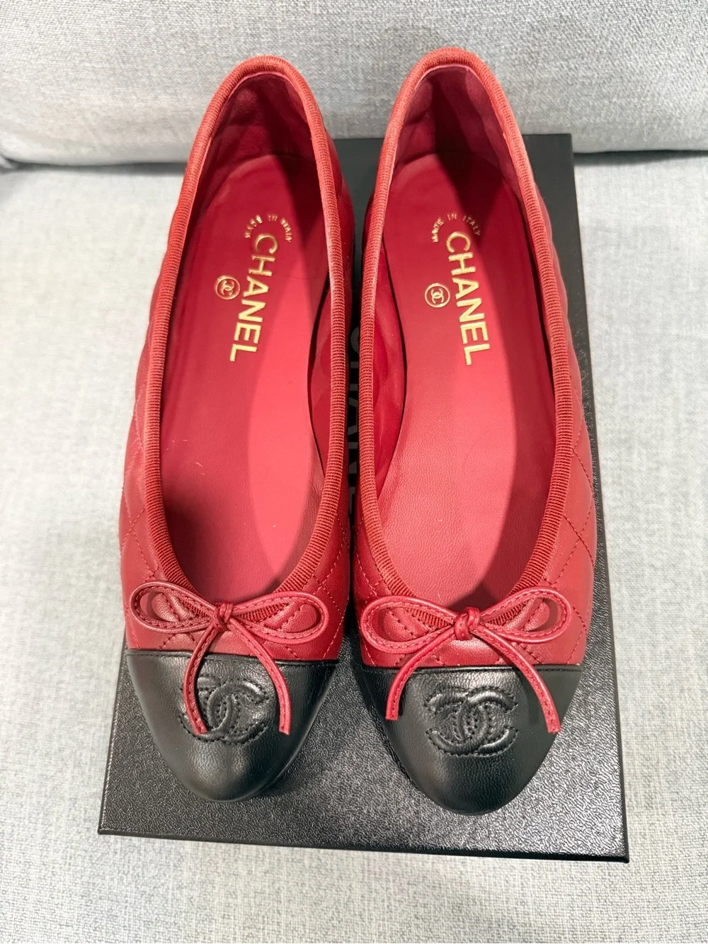 CHANEL Red Leather Ballet Flats with Black Cap Toe